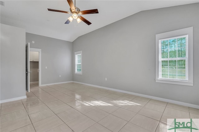 unfurnished room with ceiling fan, a healthy amount of sunlight, lofted ceiling, and light tile patterned floors