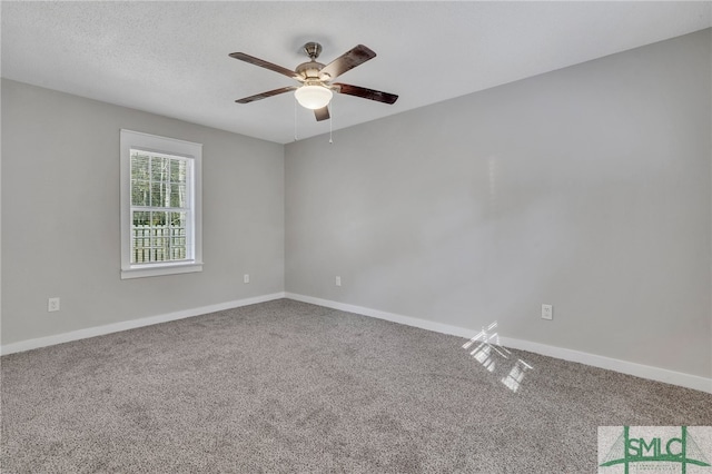 carpeted empty room featuring a textured ceiling and ceiling fan