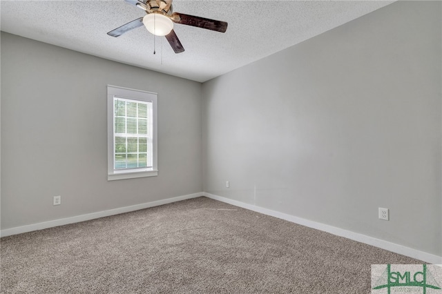 empty room with ceiling fan, carpet floors, and a textured ceiling