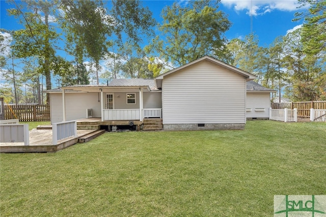 back of house featuring a yard and a wooden deck