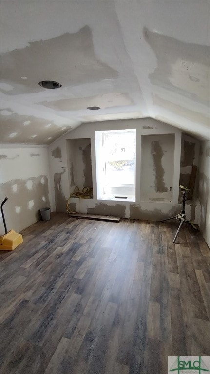 misc room with lofted ceiling and wood-type flooring