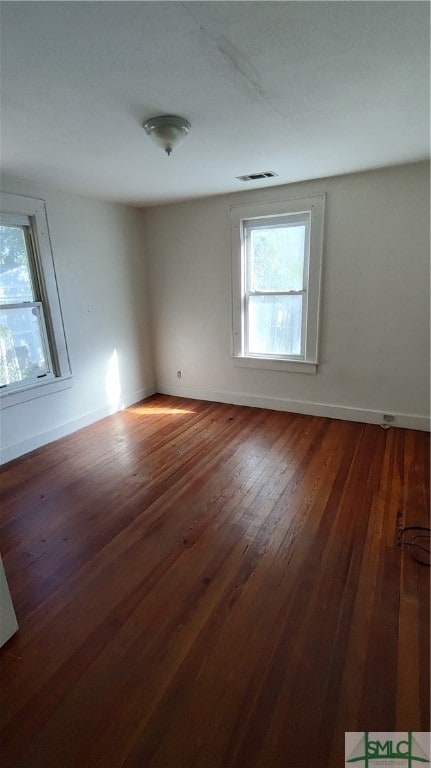 spare room with dark wood-type flooring