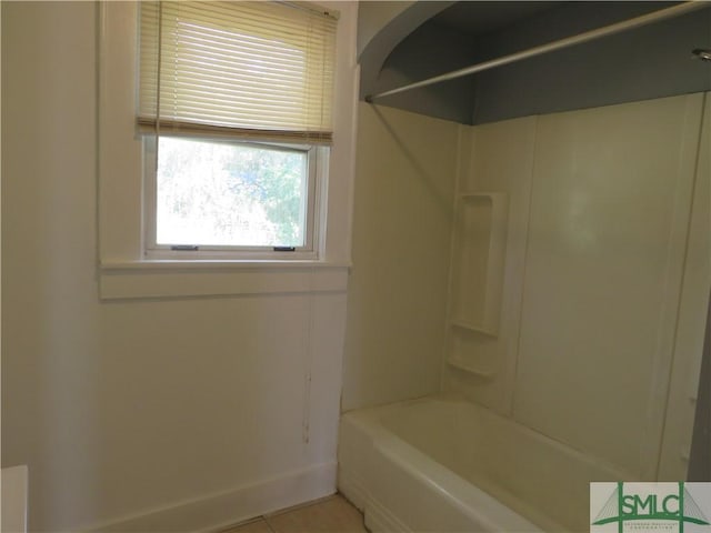 full bathroom with tile patterned floors, baseboards, and bathtub / shower combination