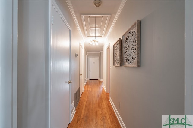 hallway featuring ornamental molding and light wood-type flooring