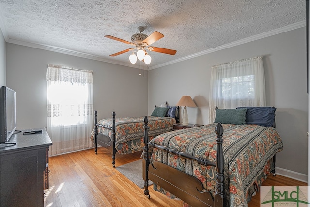 bedroom with ceiling fan, ornamental molding, a textured ceiling, and light wood-type flooring