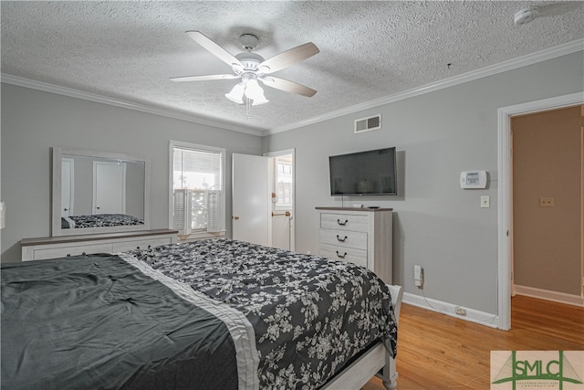 bedroom with a textured ceiling, ceiling fan, light wood-type flooring, and ornamental molding