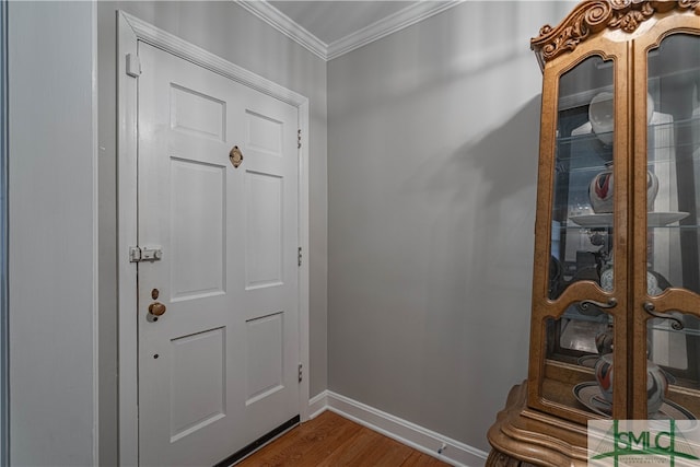 entryway featuring crown molding and hardwood / wood-style floors