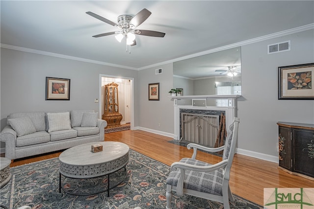 living room featuring hardwood / wood-style flooring and ornamental molding