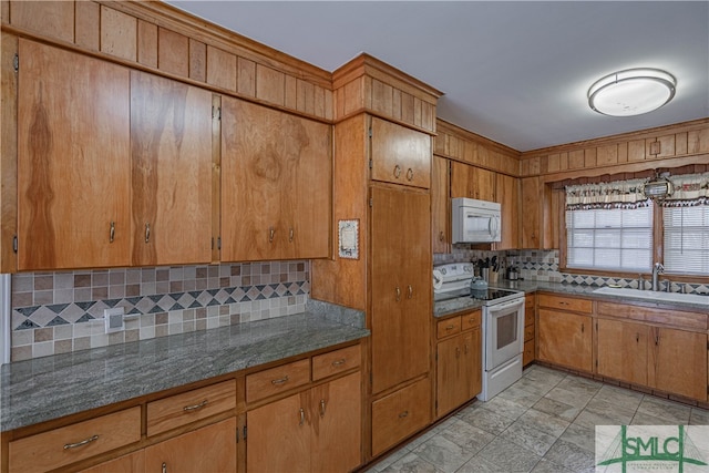 kitchen featuring white appliances, sink, and tasteful backsplash