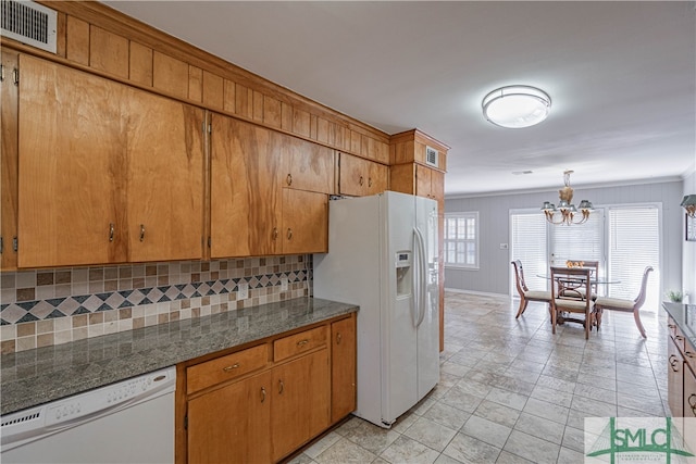 kitchen with decorative backsplash, ornamental molding, white appliances, pendant lighting, and a notable chandelier