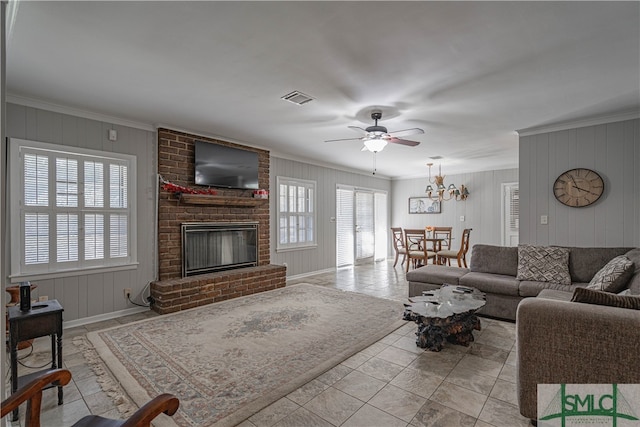 living room with ceiling fan, crown molding, and a fireplace