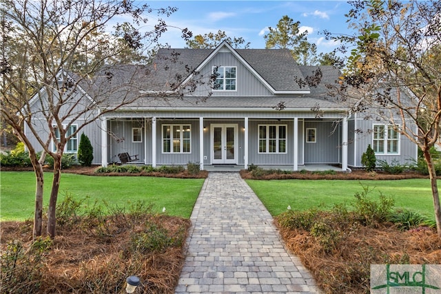 view of front of home featuring french doors and a front lawn