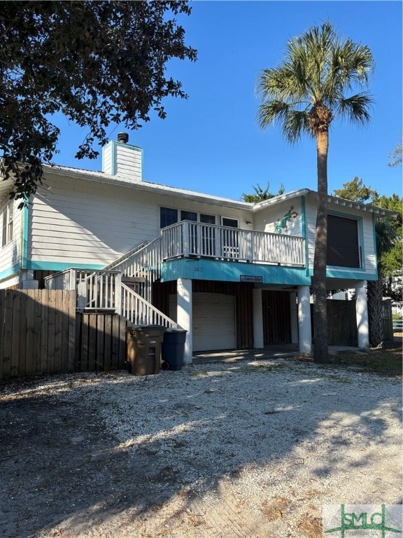 view of front facade with a garage and a deck