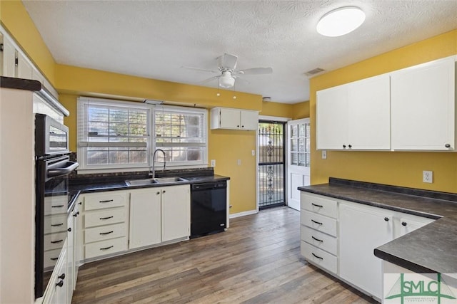 kitchen with dishwasher, a textured ceiling, white cabinetry, and sink