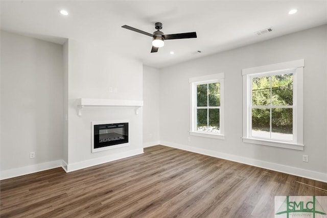 unfurnished living room featuring wood-type flooring and ceiling fan