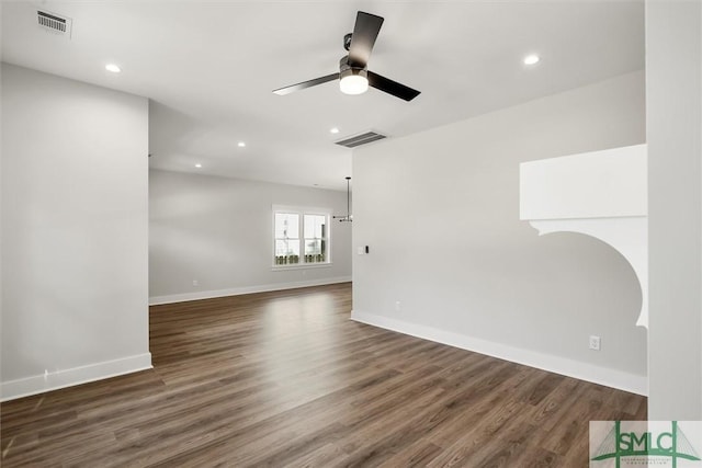 spare room featuring ceiling fan and dark hardwood / wood-style floors