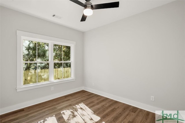 empty room featuring dark hardwood / wood-style flooring and ceiling fan