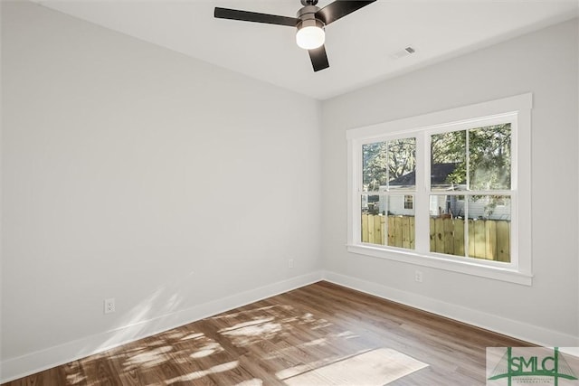 unfurnished room with ceiling fan and hardwood / wood-style floors