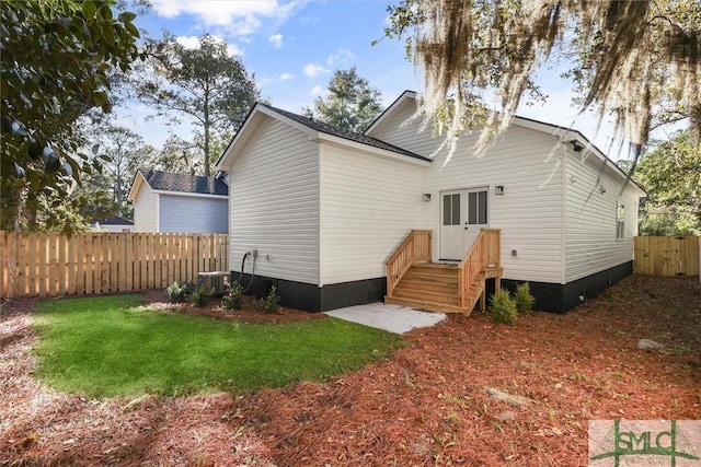 back of house featuring french doors and a yard