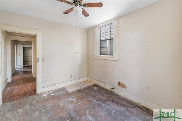 unfurnished room with ceiling fan and dark parquet floors