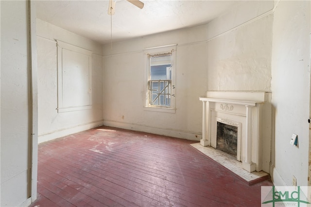 unfurnished living room with ceiling fan and light hardwood / wood-style flooring