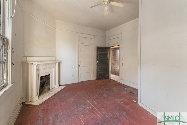 unfurnished living room featuring ceiling fan and hardwood / wood-style flooring