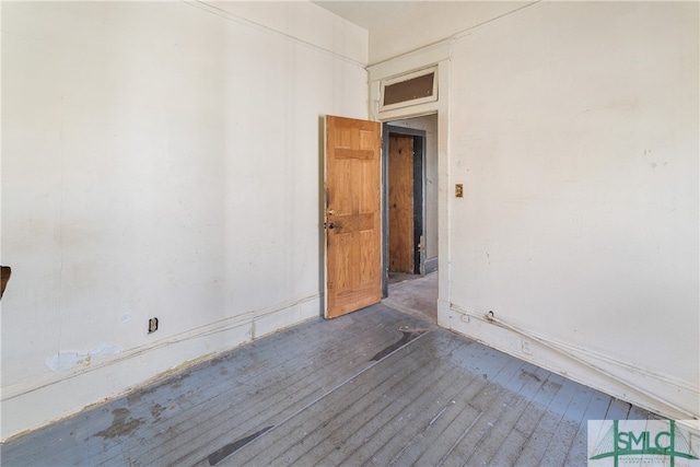 empty room with dark wood-type flooring