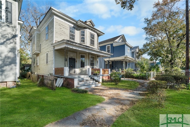 view of front of property with covered porch and a front lawn