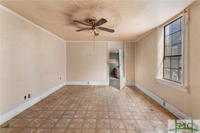 empty room with ceiling fan, ornamental molding, and a textured ceiling