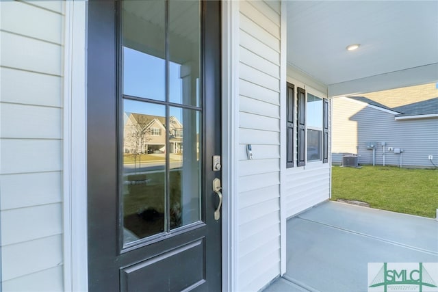 doorway to property with central air condition unit and a porch