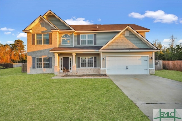 craftsman inspired home featuring a garage and a front yard