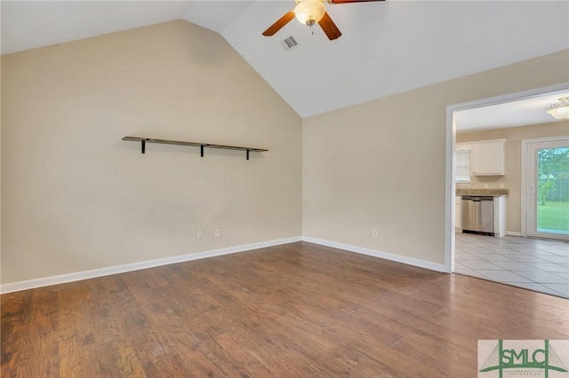 unfurnished room with lofted ceiling, ceiling fan, and light wood-type flooring