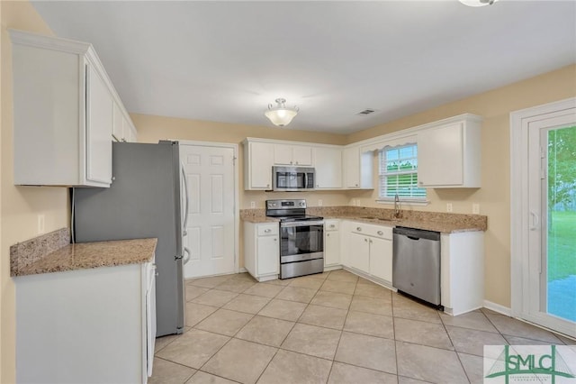 kitchen with sink, white cabinets, and appliances with stainless steel finishes