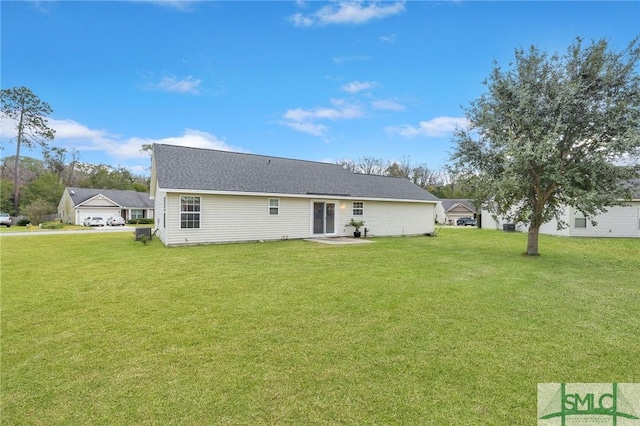 rear view of house featuring a patio area and a yard