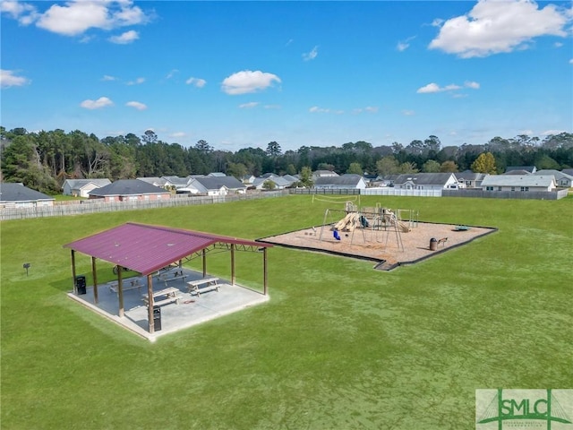 surrounding community featuring a playground and a lawn