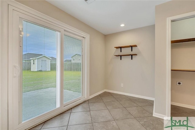 doorway to outside with light tile patterned floors and a wealth of natural light