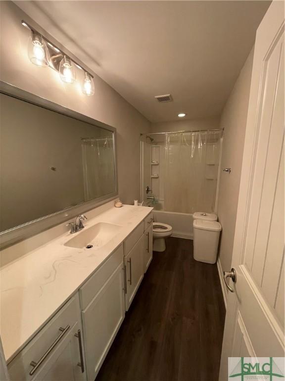 full bathroom with shower / bathing tub combination, vanity, toilet, and hardwood / wood-style floors