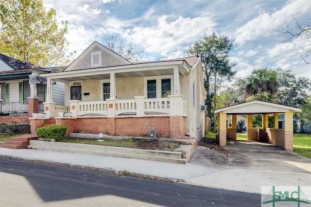 view of front of house featuring a porch and a carport