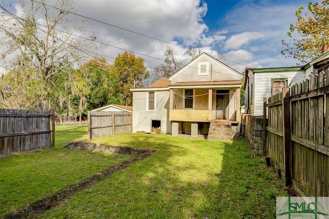 back of house with a yard