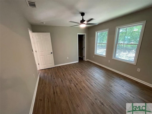 unfurnished bedroom featuring dark hardwood / wood-style floors and ceiling fan