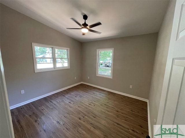 spare room featuring dark hardwood / wood-style flooring, vaulted ceiling, and ceiling fan