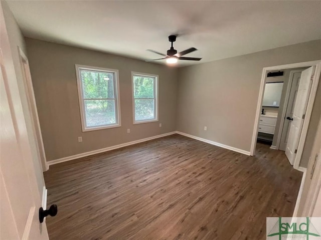 unfurnished bedroom with ceiling fan and dark wood-type flooring