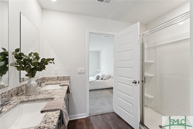 bathroom with vanity, hardwood / wood-style flooring, and an enclosed shower