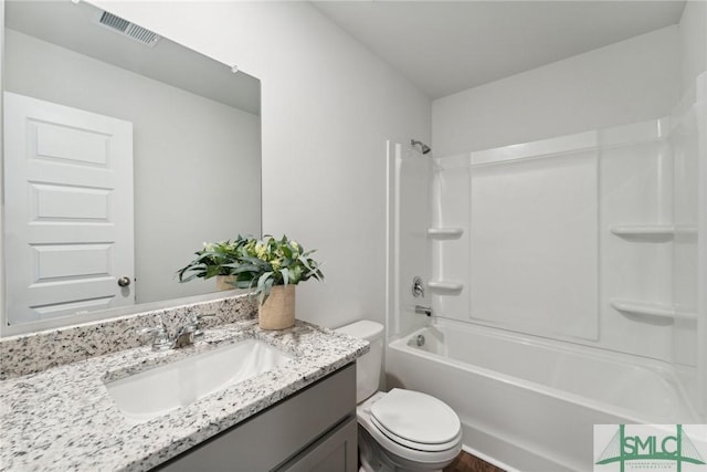 full bathroom featuring washtub / shower combination, vanity, and toilet