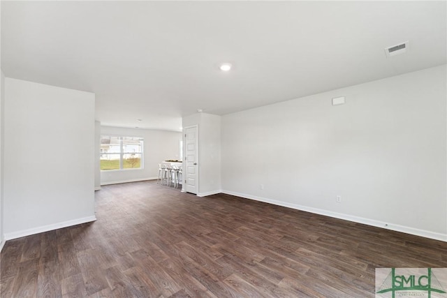 empty room with dark hardwood / wood-style floors