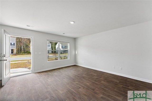 spare room with wood-type flooring and a wealth of natural light