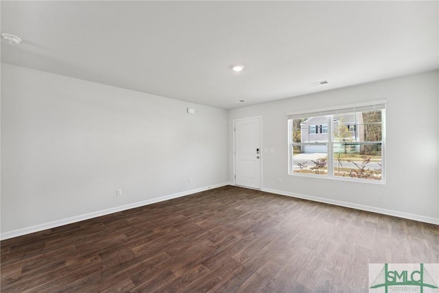 empty room featuring dark hardwood / wood-style flooring