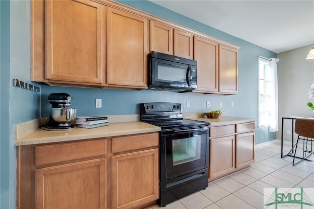 kitchen featuring light tile patterned flooring and black appliances