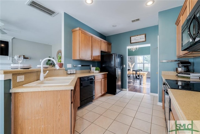 kitchen featuring ceiling fan, sink, kitchen peninsula, light tile patterned flooring, and black appliances