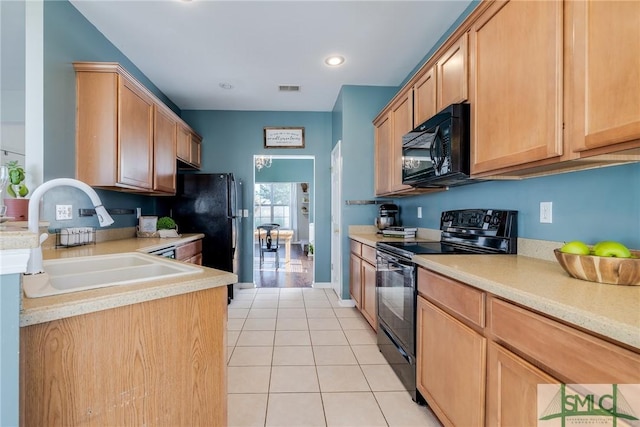 kitchen featuring light tile patterned floors, sink, and black appliances